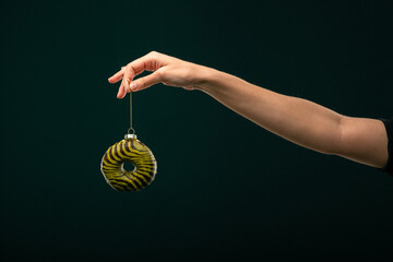 Donuts, bun, croissant Christmas toy on a black background. Creative collage.