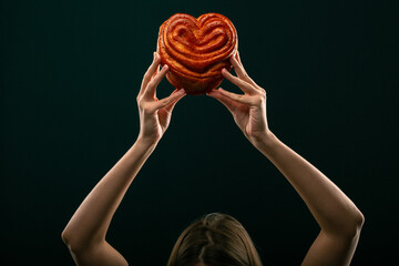 Donuts, bun, croissant Christmas toy on a black background. Creative collage.