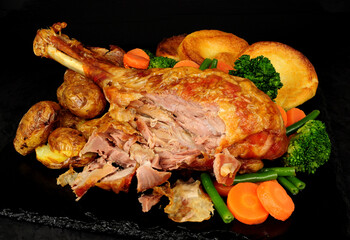 Roast turkey leg meal with potatoes, vegetables and Yorkshire puddings