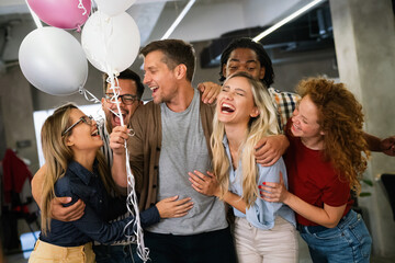 Happy diverse business team celebrating success and having fun all together in office