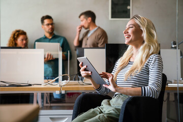 Group of young multi-ethnic startup business team collaborating on project in modern office