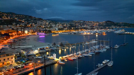 Fototapeta premium Aerial view of Sanremo at night, Italy. Port and city buildings