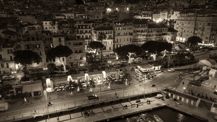 Aerial view of Sanremo at night, Italy. Port and city buildings