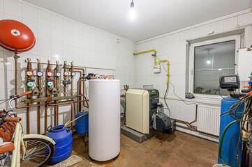 interior apartment room boiler room. heating system, pipes and appliances