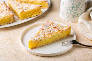 A piece of Custard cream cake with almonds. Traditional italian pastry, dessert - torta della nonna or grandmother's cake.