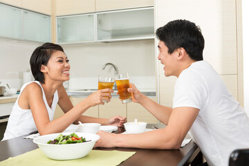 Happy Asian couple eating at home