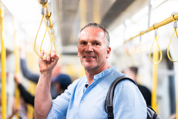 Smiling businessman commuting by train