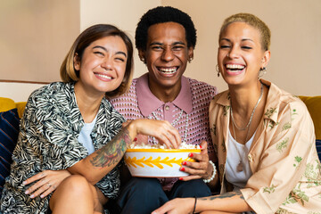 Group of friends bonding at home, LGBTQ and diversity concepts - Homosexual couple and fluid gender non binary young man with LGBT cross dressing clothing style having fun in the apartment