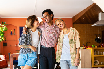 Group of friends bonding at home, LGBTQ and diversity concepts - Homosexual couple and fluid gender non binary young man with LGBT cross dressing clothing style having fun in the apartment