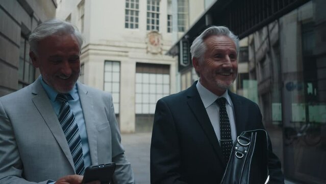 Cinematic image of senior businessmen at work in London. Business man entrepreneur making deals with partners over future investments. Concepts about finance, entrepreneurship and lifestyle.