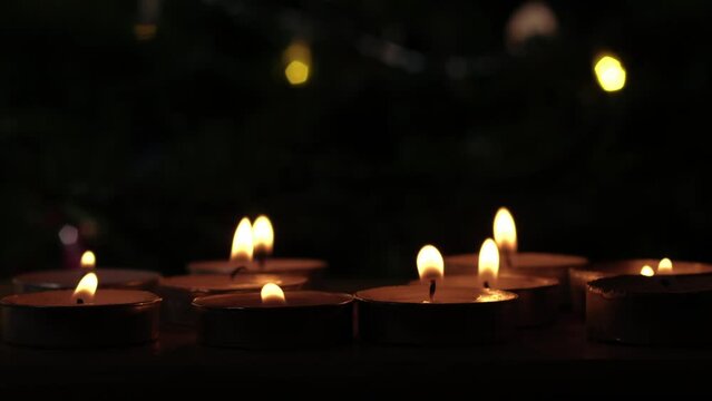 Tealight candles flickering with bokeh background