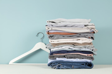 stack of folded clothes, blue background