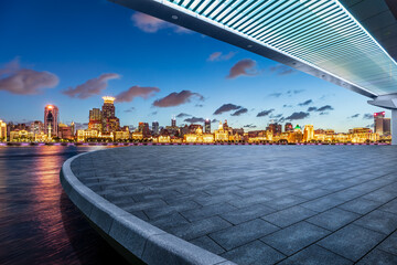 Empty square floor and pedestrian bridge with city skyline at night in Shanghai - Powered by Adobe