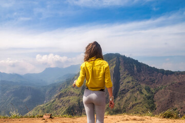 Rear view of lady enjoy at landscape Adam's peak mountain at tropical journey Sri Lanka, Ella,...