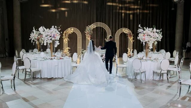a young couple enters the banquet hall after registering their marriage