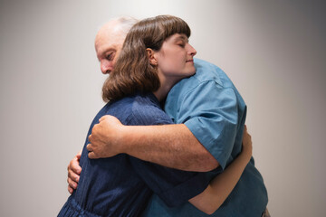 Side view of father hugging daughter