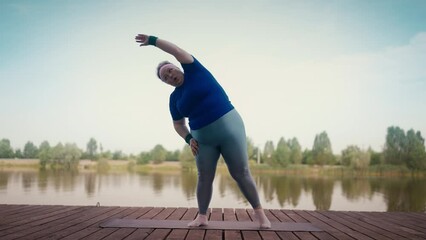 Tired overweight woman exercising near lake working hard to lose weight, fitness