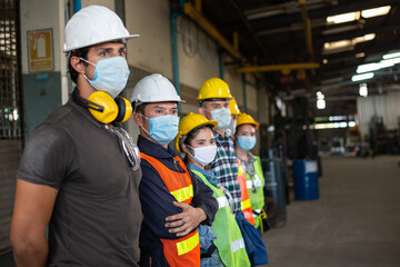Group of industrial or engineer corporate workers wear protective mask and hard hat helmet standing...