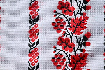 Overhead view of a fragment of a Ukrainian embroidered towel, oak leaves, viburnum, black and red embroidery. Top view free place for text 