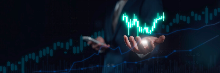 investment and finance concept, businessman touching virtual trading graph and blurred light on...