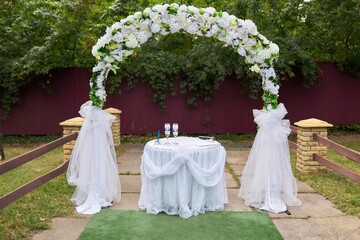 Wedding ceremony. Very beautiful and stylish wedding arch, decorated with various fresh flowers and...
