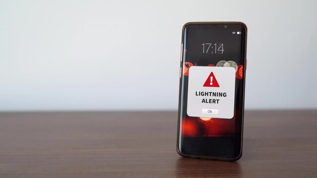 New lightning storm alert notification on the smart phone. Thunderstorm concept.