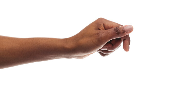 African american woman holding something in fist, ready to share
