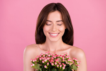 Photo of attractive joyful girl with roses bunch enjoy eco bio skincare product isolated over pastel color background