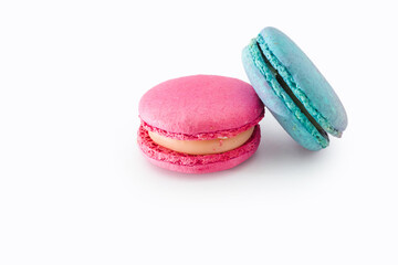 Tasty colorful macarons isolated on white background. Sweet macaroons dessert. Two multi-colored blue and pink macaroons. French pastry, almond cookies from egg whites.
