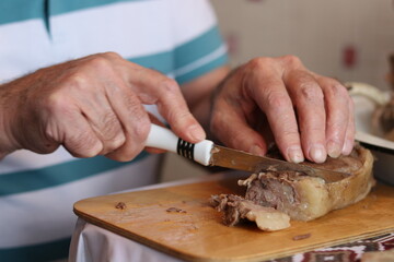 person cutting meat