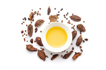 Fototapeta premium Top view of Dry organic Black cardamom (Amomum subulatum), along with its essential oil.