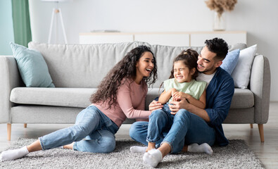 Middle Eastern Parents Having Fun With Their Little Daughter At Home