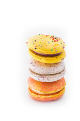 Sweet colorful yummy macarons isolated on white background. Brightly colored stacked macaroons. Tasty macaron. Three multi-colored orange, pink and yellow macaroons. French pastry, food concept