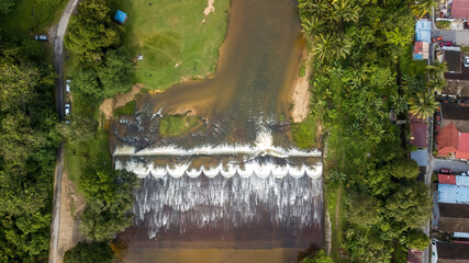 Aerial view of the Water flowing from the stream to the dam in Malaysia. - obrazy, fototapety, plakaty