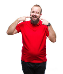 Fototapeta premium Young caucasian hipster man wearing red shirt over isolated background smiling confident showing and pointing with fingers teeth and mouth. Health concept.