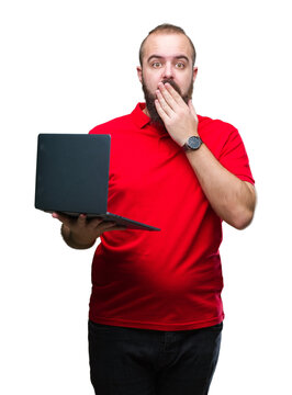 Young caucasian man using computer laptop over isolated background cover mouth with hand shocked with shame for mistake, expression of fear, scared in silence, secret concept