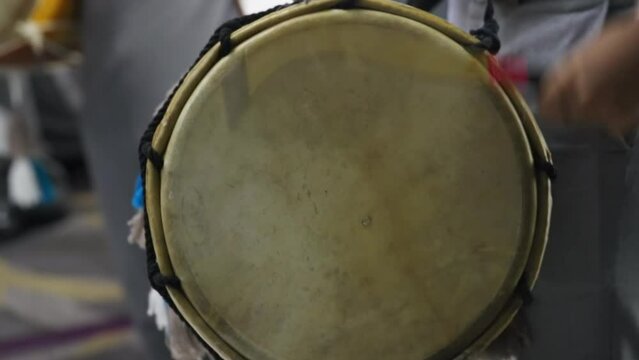 Dhol drummer rhythmic hitting the dhol in slow motion. Close up.