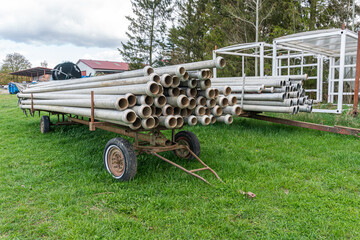 A lot of straight metal pipes, tubes loaded on a trailer
