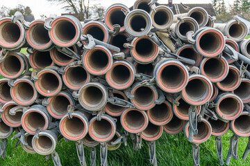 A lot of straight metal pipes, tubes loaded on a trailer