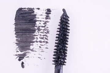 Black mascara brush stroke, macro. Mascara brush and black brush stroke, cosmetic object.