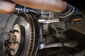 car brake system repair with shallow depth of field - obrazy, fototapety, plakaty