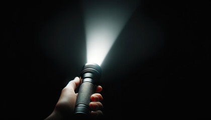 Beam of light from a flashlight shining into the darkness.Metaphor for hope, guidance, or enlightenment in challenging times. - obrazy, fototapety, plakaty