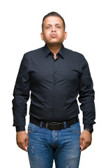 Handsome middle age arab business man over isolated background puffing cheeks with funny face. Mouth inflated with air, crazy expression.