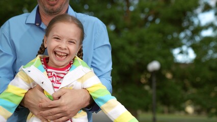 happy father runs through park behind little daughter, happy family, child kid girl running father,...