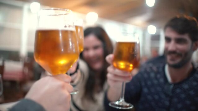 Toast toasts of friends drinking alcohol in terraza in sumer party . Fun time with friends toasting or making cheers. young cheerful people chatting and drinking sitting making a toast at restauran
