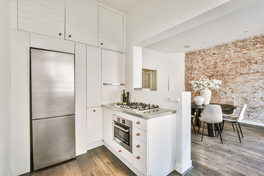 Modern kitchen with brick wall accent and dining area