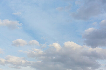 Fototapeta premium Morning sky. Beautiful fluffy clouds painted in delicate colors at sunrise. Multicolor background or wallpaper