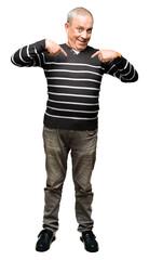 Handsome senior man wearing winter stripes sweater looking confident with smile on face, pointing...