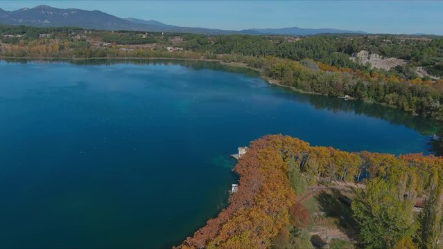 Banyoles Lake shore in autumn with blue waters, Girona, Catalonia