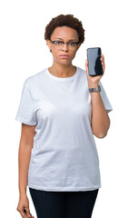 Young african american woman showing smartphone screen over isolated background with a confident expression on smart face thinking serious